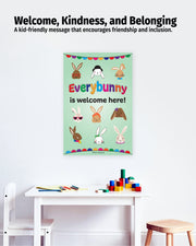 Poster with 'Everybunny is welcome here!' message on a wall above a table with toys.