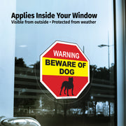 Window decal with 'Beware of Dog' warning sign applied inside a window.