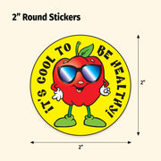 Round sticker with a red apple character wearing sunglasses and text 'It's cool to be healthy' on a yellow background.