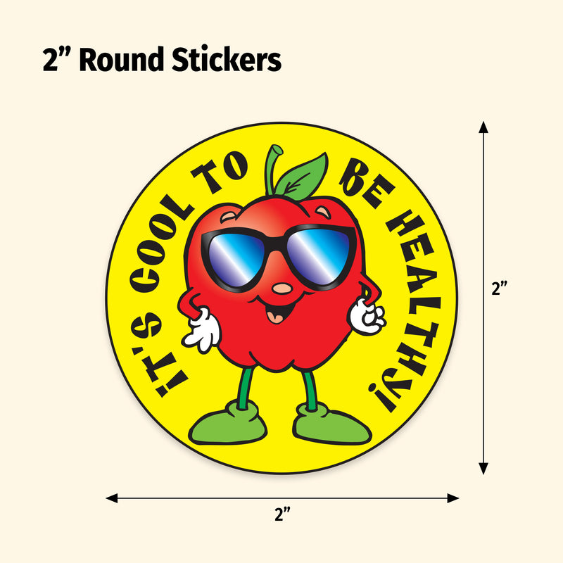 Round sticker with a red apple character wearing sunglasses and text 'It's cool to be healthy' on a yellow background.