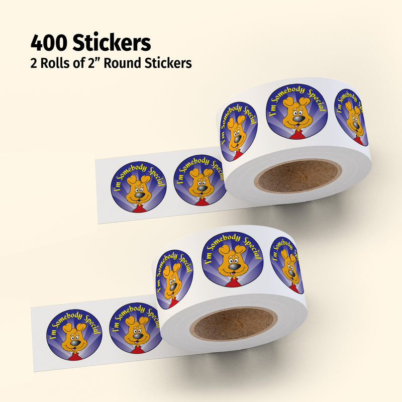 Two rolls of 2" round stickers with a cartoon character on a beige background