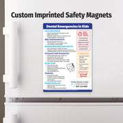 Custom imprinted safety magnet on a refrigerator door with text about dental emergencies in kids.